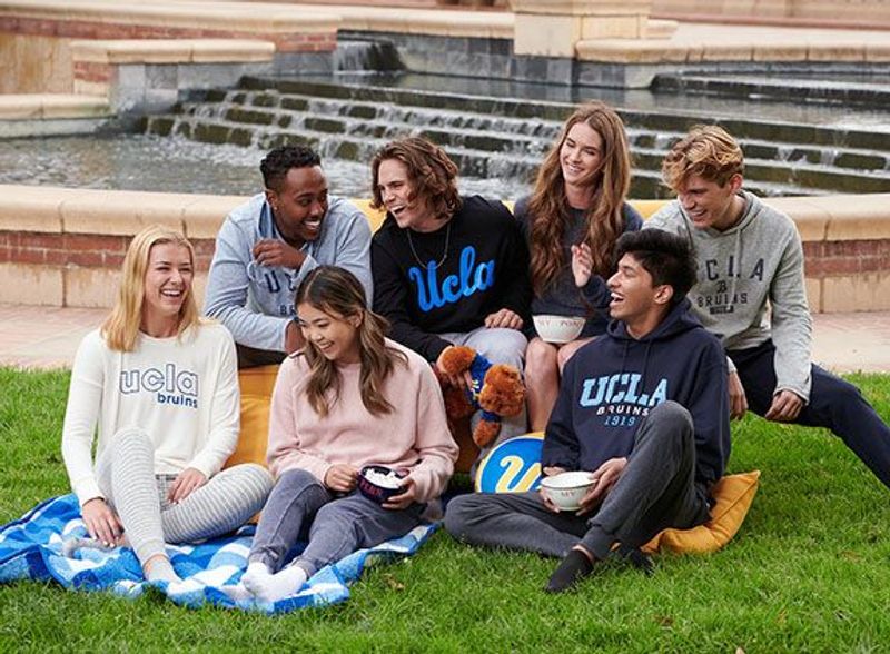 A group of UCLA students pose for a photo in front of a fountain
